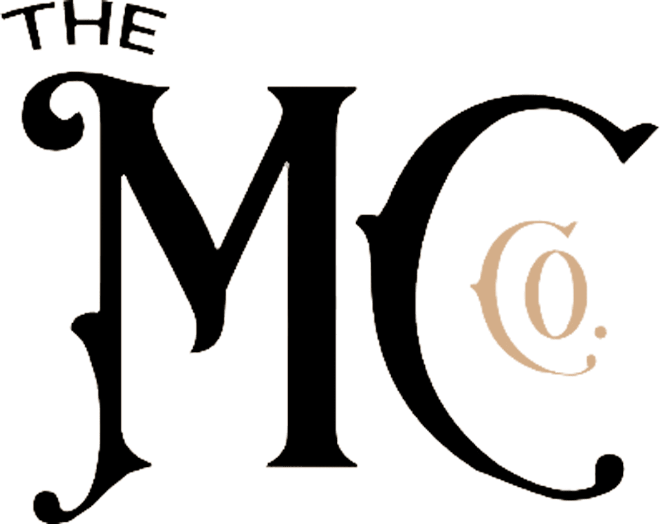 MarreroContractingSmallLogo-Initials-bg Stylized text "THE MC" in black on a beige background. "THE" is smaller and positioned above the left part of the letter "M".